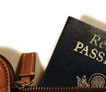 Resume styled passport peeking from leather bag